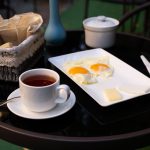 Cup-tea-fried-eggs-black-table